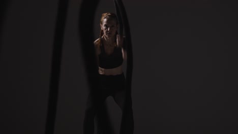 Studio-Shot-Of-Mature-Woman-Wearing-Gym-Fitness-Clothing-Doing-Cardio-Exercise-With-Battle-Ropes